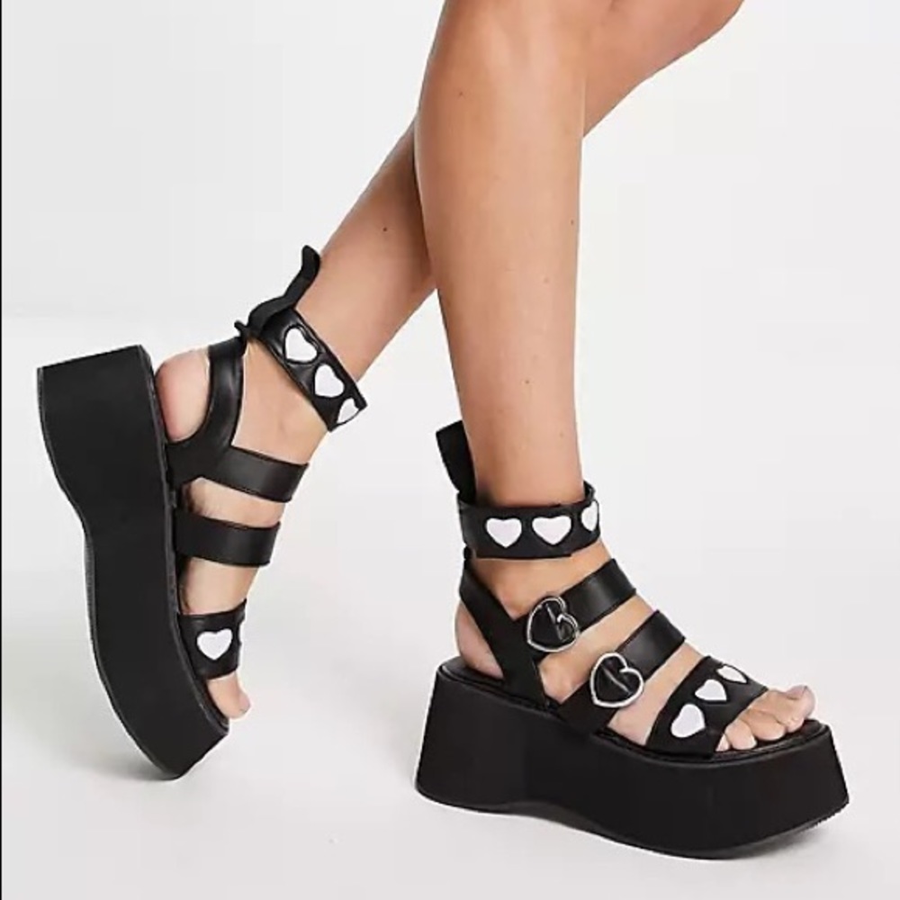 Koi Footwear Lovergirl flatform sandals in black with 3D pink hearts.